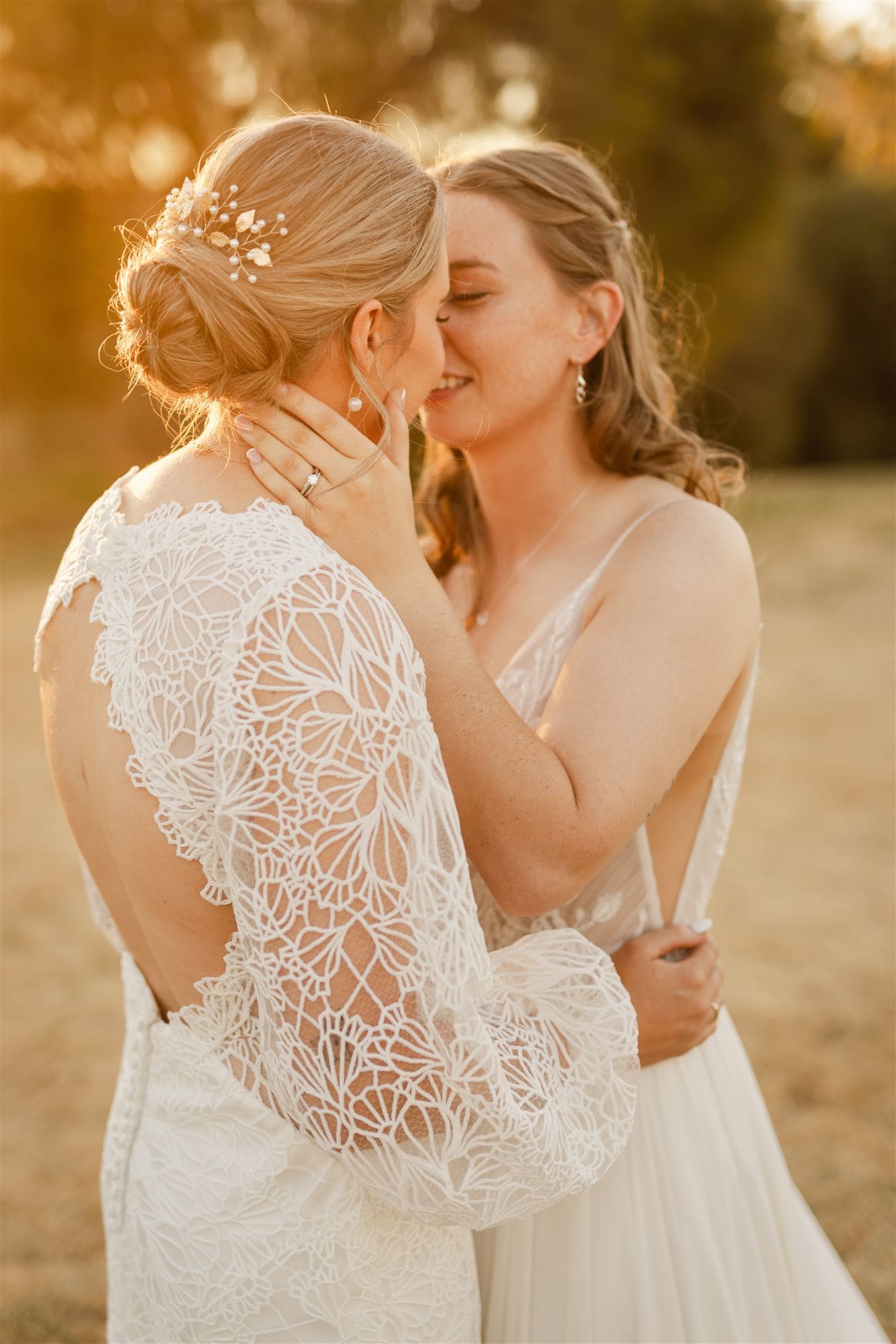 Perth wedding photographer two brides wearing white dresses about to kiss with warm sunset golden light at Perth wedding