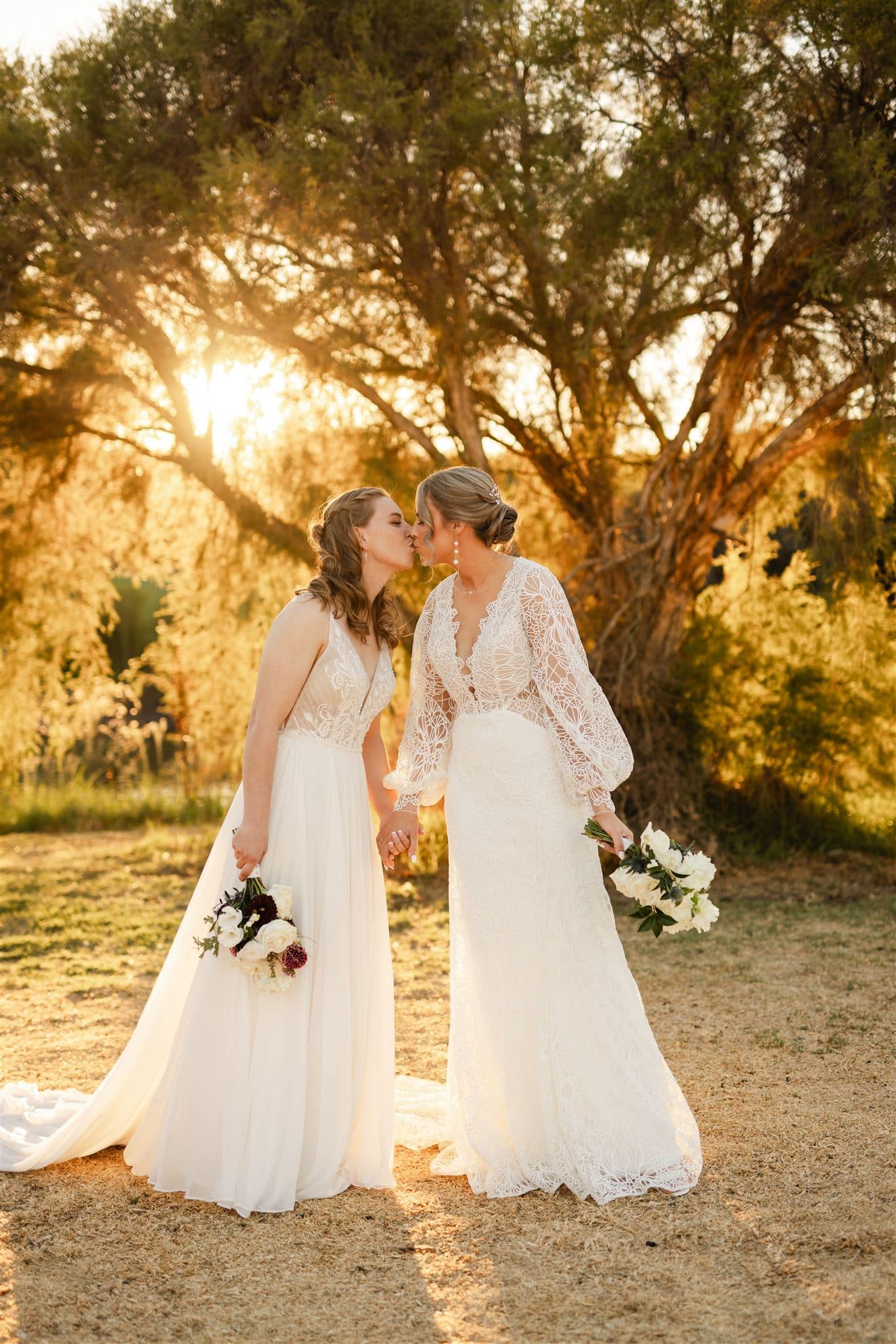 Perth wedding photographer two brides wearing white dresses kissing with warm sunset golden light at Perth wedding