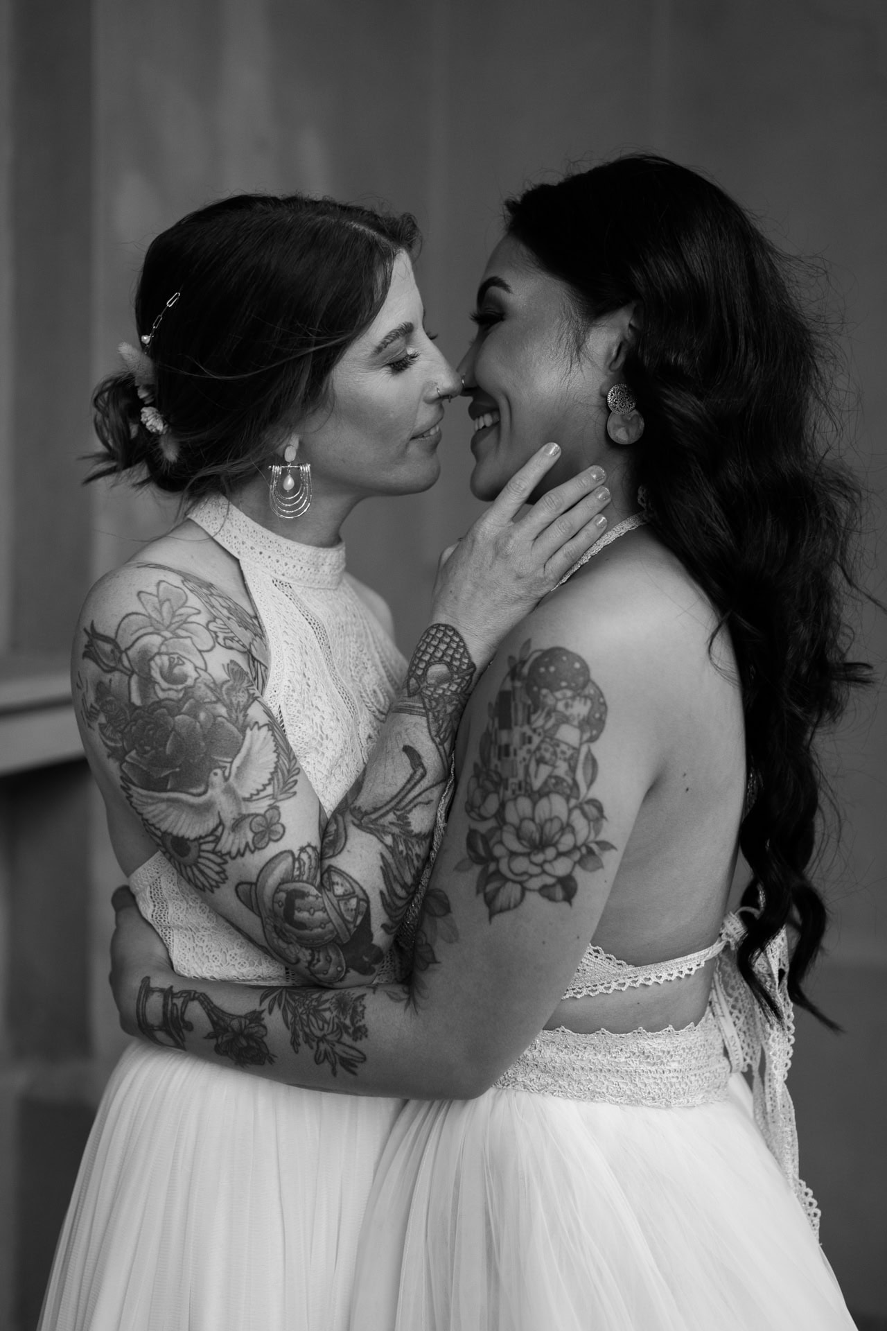 Perth wedding photographer two brides with tattoo sleeves about to kiss at wedding in Perth