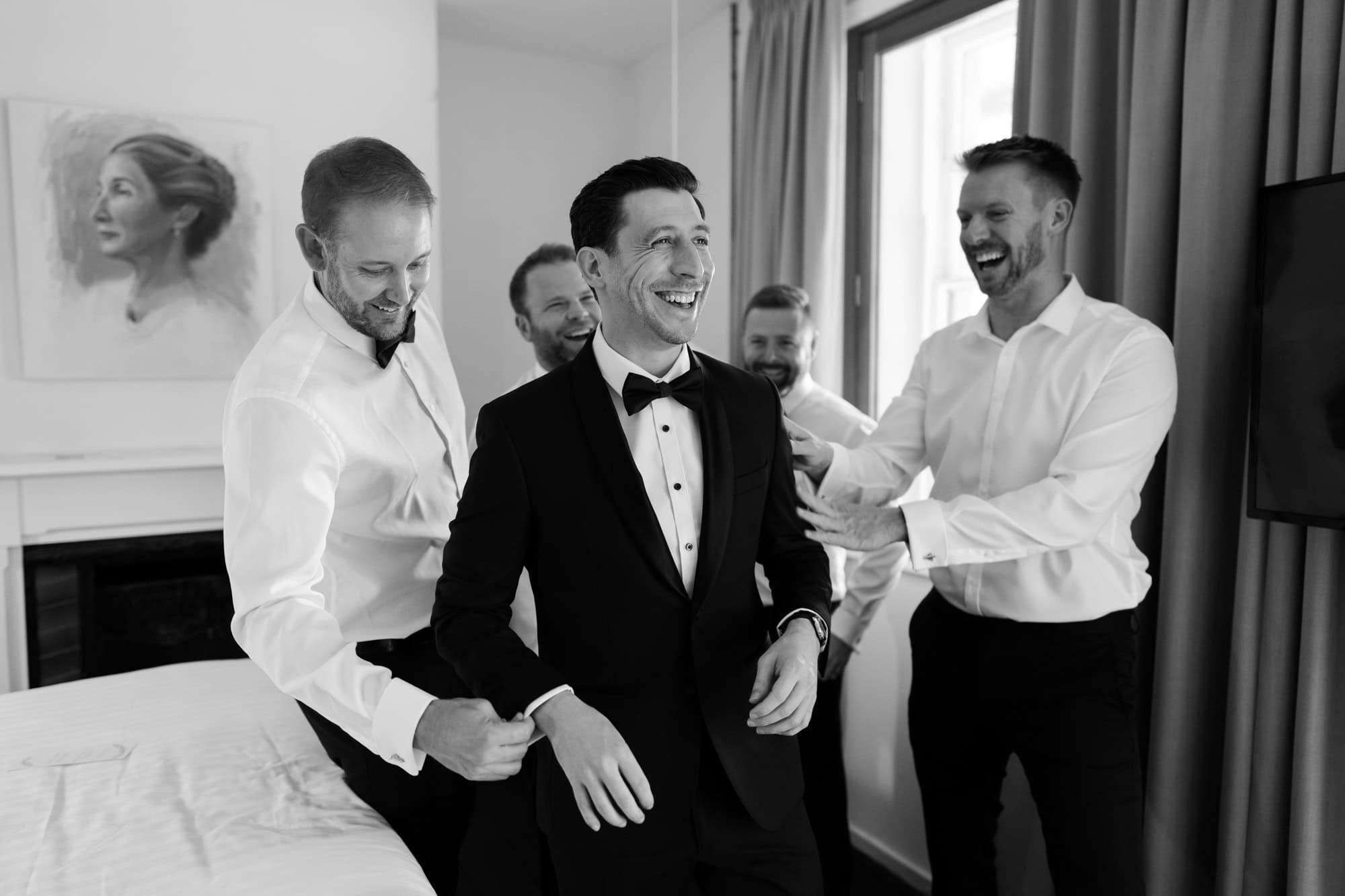 wedding photos Perth groom in black suit and bowtie getting ready with groomsmen