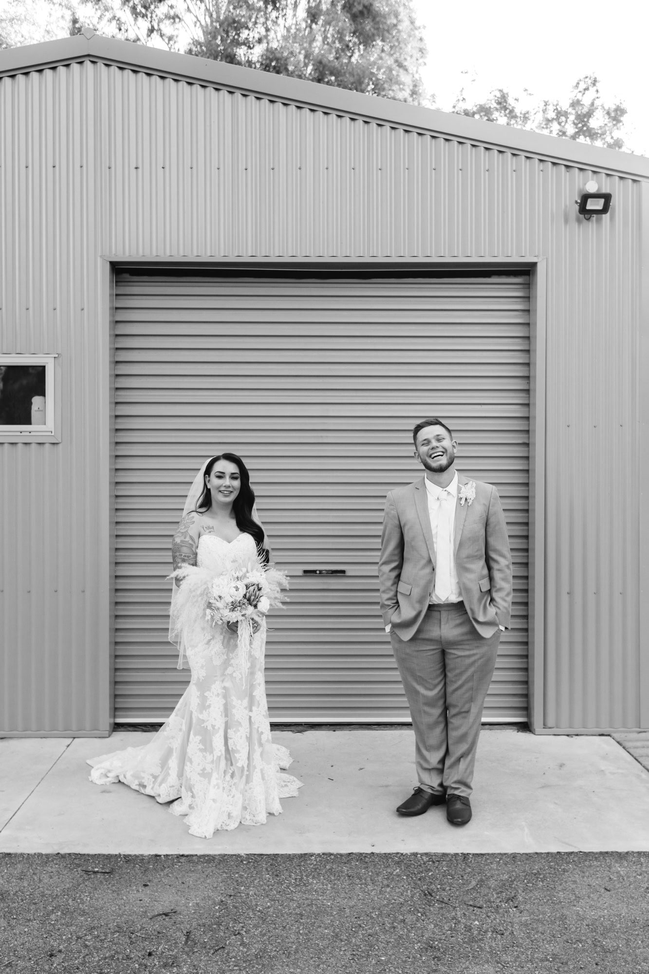 wedding photos Perth bride and groom standing in front of metal roller door laughing