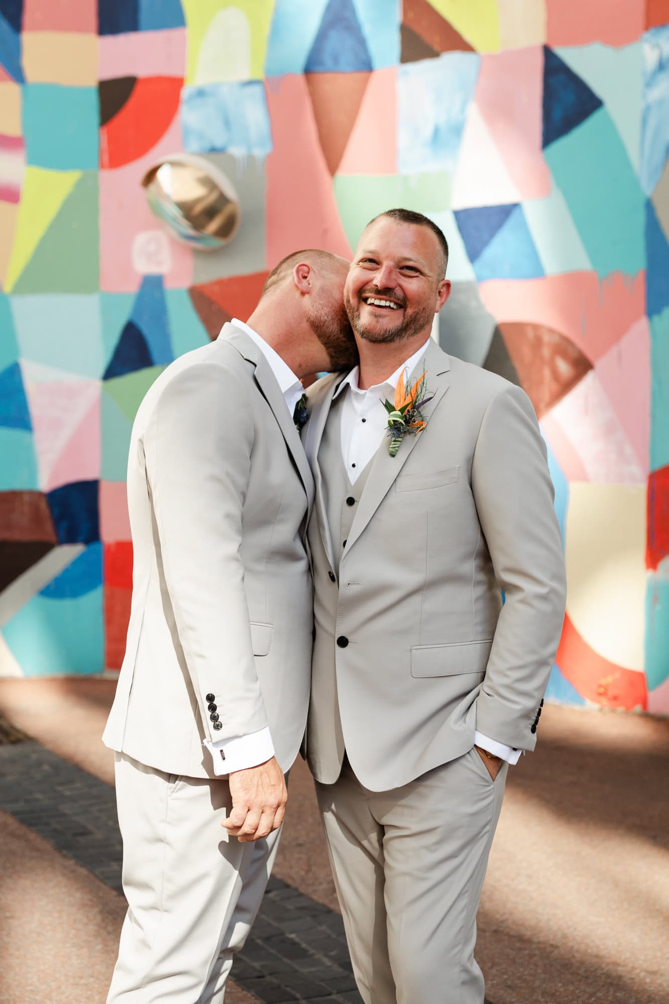 wedding photos Perth groom wearing cream suit kissing neck of groom in cream suit