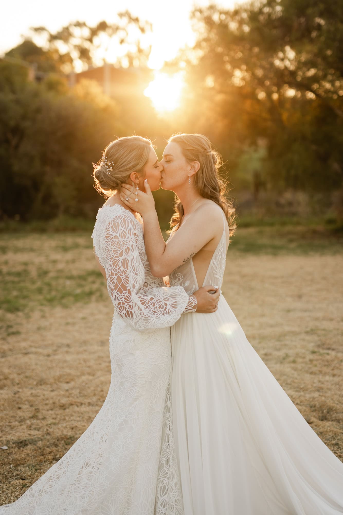 wedding photos Perth two brides wearing white dresses kissing at sunset